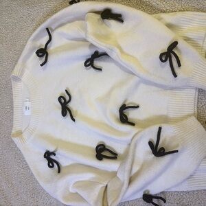 Chic Cream Sweater with Black Bow Details